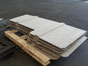 Box pad divider boards on a pallet.