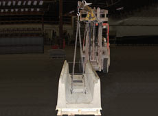 Image of a fork lift and 4-Way lifting chain hooked up to Concast's heavy channel with eye bolts threaded into the cast-in inserts located on the channel floor